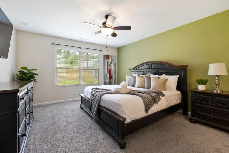 Primary bedroom with green accent wall