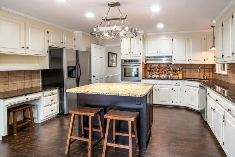 Kitchen with marble island and stools