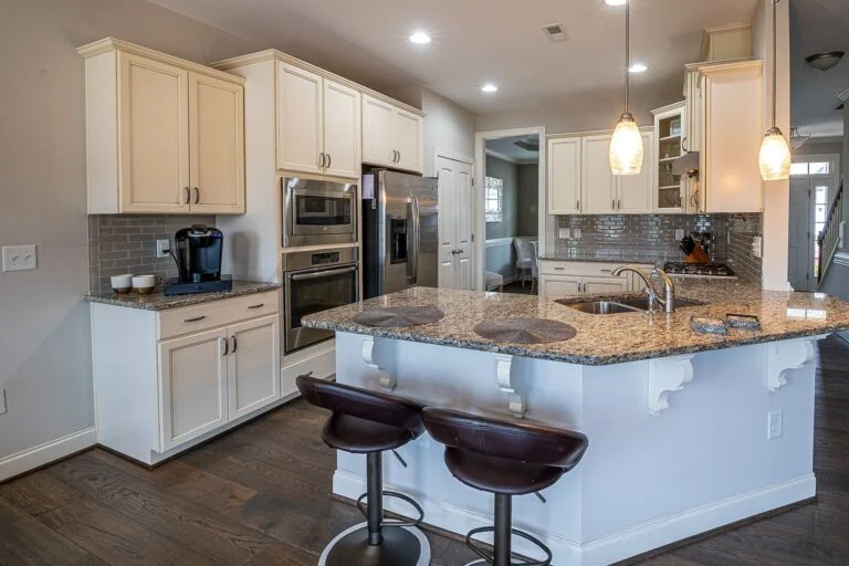 Kitchen with granite island and bar stools